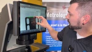 Technician performing optical comparator calibration to ensure accurate measurements and maintain consistent inspection quality.
